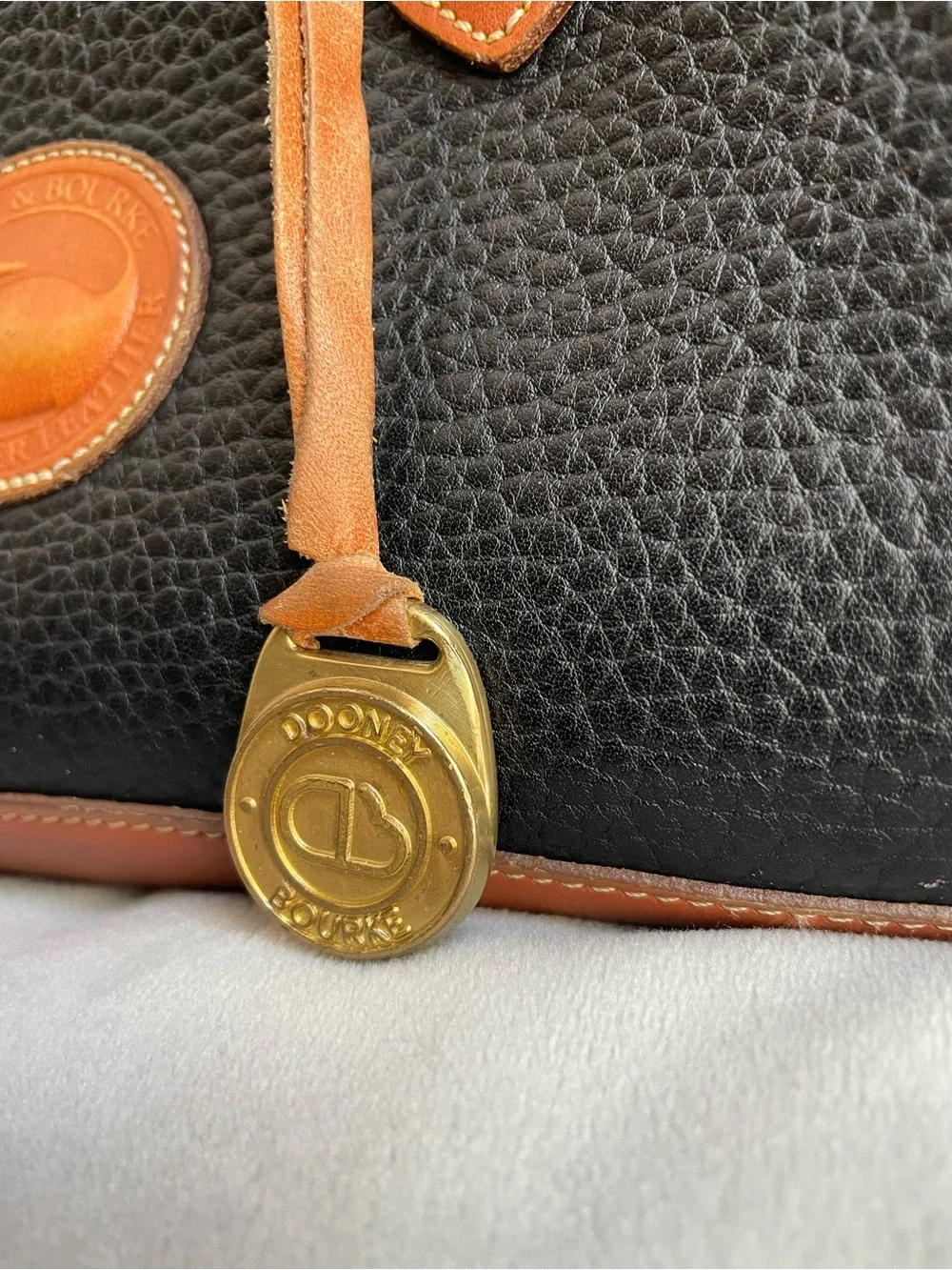 Dooney & Bourke Vintage All Weather Leather Handbag Black Tan Duck Logo AWL